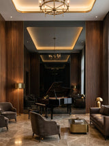 Black Mirror wood veneer panel accent wall reflecting a grand piano in an elegant lounge