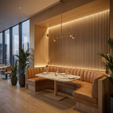 Natural oak acoustic wood slat wall with warm lighting behind a restaurant booth