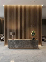 Royal Oak WPC fluted panel feature wall with integrated lighting behind a marble reception desk