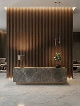 Floor-to-ceiling walnut WPC fluted 3D wall panels behind a modern reception desk