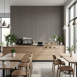 Floor-to-ceiling ash gray acoustic wood slat panel wall behind a cafe counter