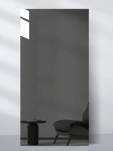 Gray reflective wall panel sample showing a minimalist chair and side table