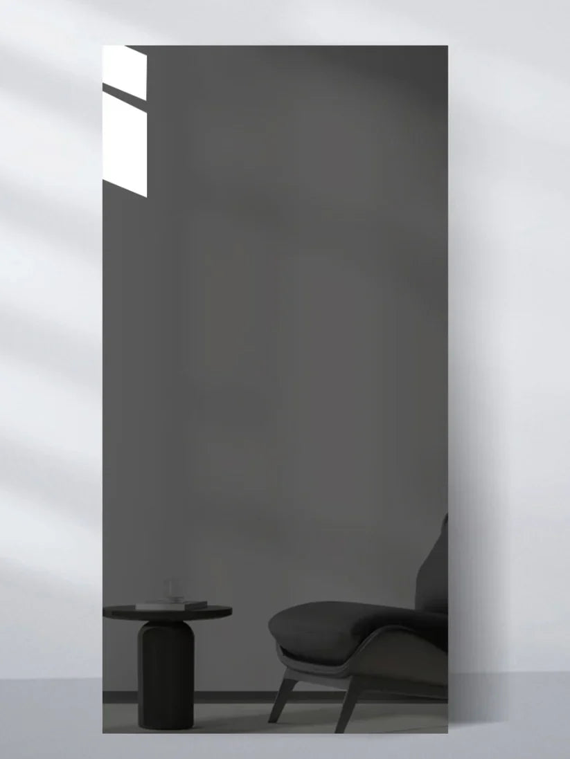 Gray reflective wall panel sample showing a minimalist chair and side table