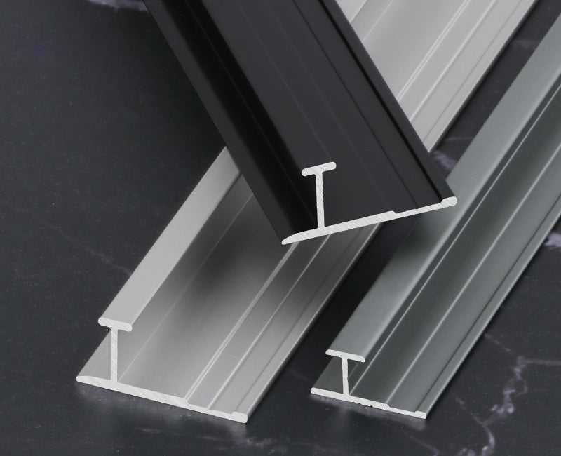 Black, silver and gray aluminum H-joint connection trims shown in cross-section