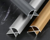 Silver, gray, and gold curved aluminum wall panel trim samples showing profile cross-sections