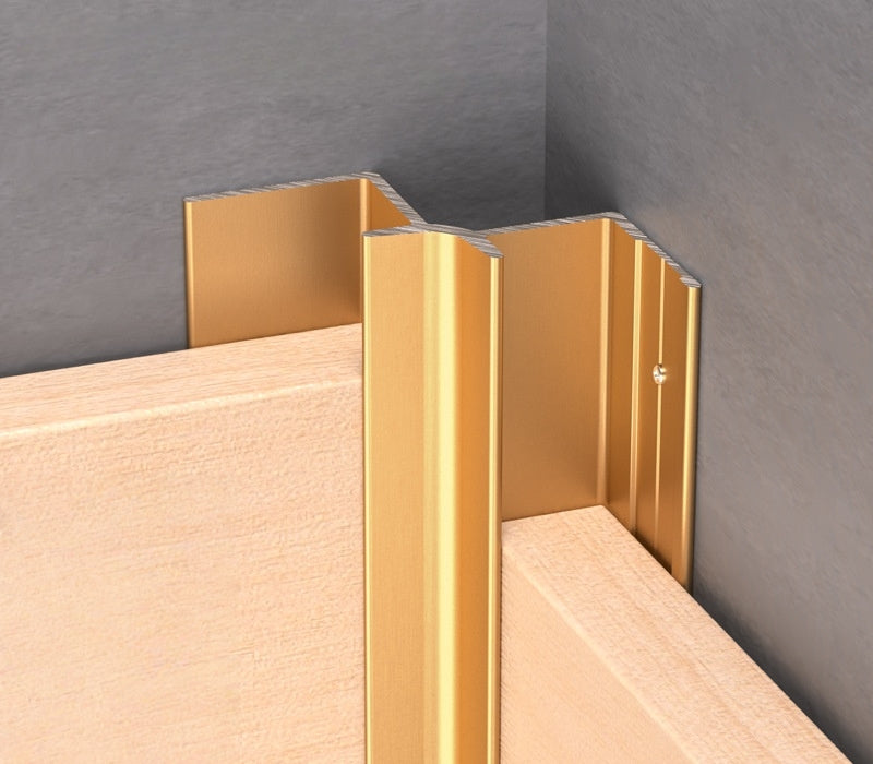 Gold 3mm aluminum inside corner trim fitted between light wood panels at a wall corner