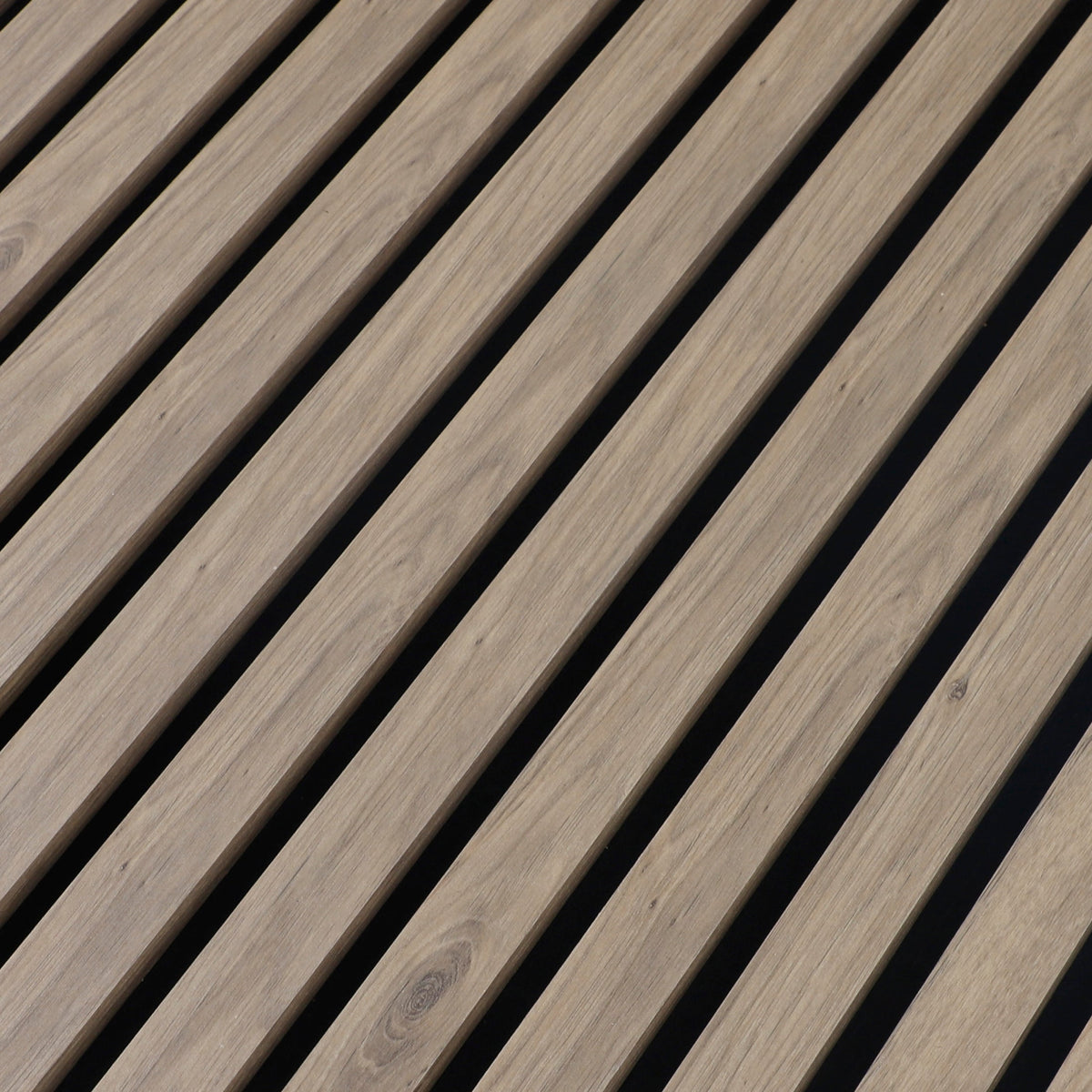 Close-up of white oak veneer grain and evenly spaced slats on black acoustic backing