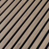 Close-up of white oak veneer grain and evenly spaced slats on black acoustic backing