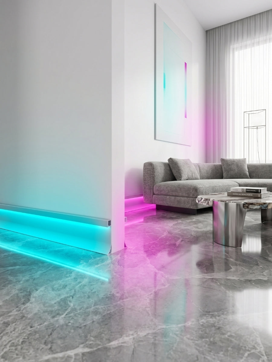 White aluminum LED baseboard molding with cyan and pink RGB lighting in a modern living room