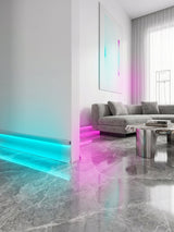 White aluminum LED baseboard molding with cyan and pink RGB lighting in a modern living room