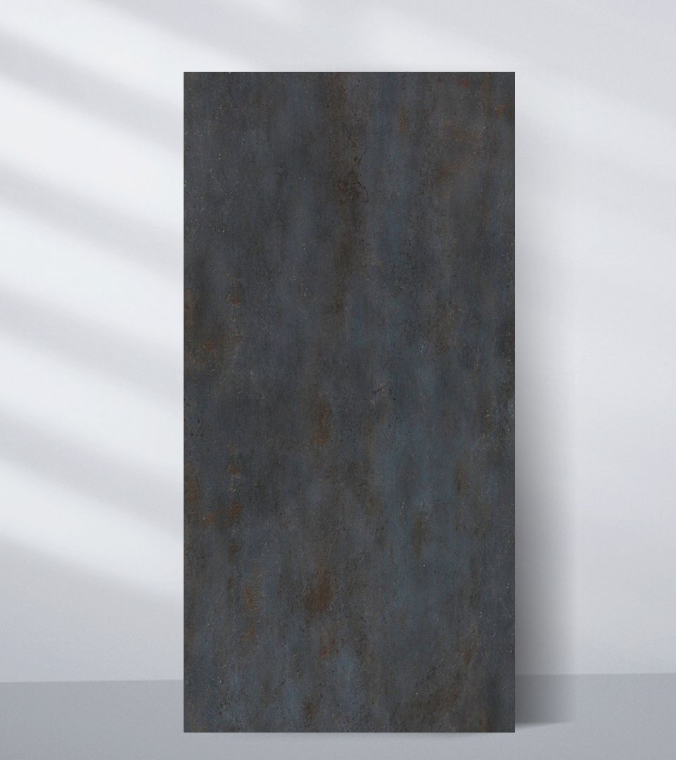Dark charcoal PVC sheet sample with a mottled blue-gray and rust-toned industrial finish