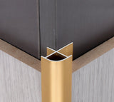 Gold 3mm aluminum outside corner trim aligned with two wall panels at an external corner