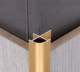 Gold curved aluminum wall panel trim sample positioned on an outside panel corner