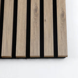 Close-up of five white oak veneered slats showing natural grain and black acoustic backing