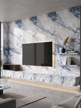 Modern TV feature wall clad in Calacatta Azur PVC marble sheets with vivid blue and gray veining