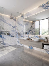 Modern bathroom with Calacatta Azur PVC marble sheets surrounding the glass shower and double vanity