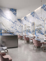 Salon styling stations along Calacatta Azur PVC marble sheet feature walls with bold blue veining