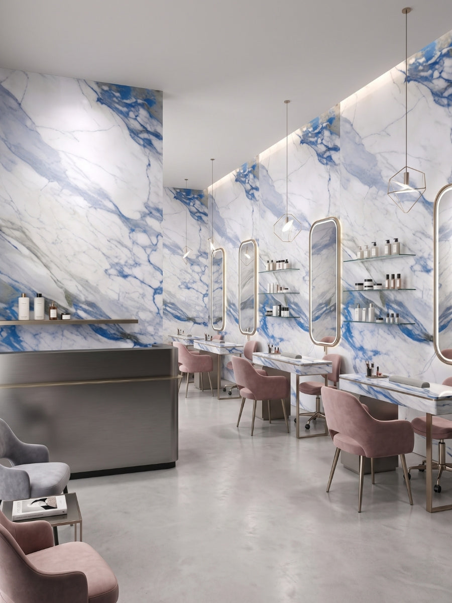 Salon styling stations along Calacatta Azur PVC marble sheet feature walls with bold blue veining