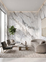 White deep-vein PVC marble sheets installed across a modern living room feature wall