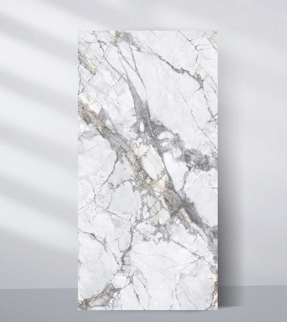 White PVC marble sheet sample with deep intersecting gray veins and subtle gold accents