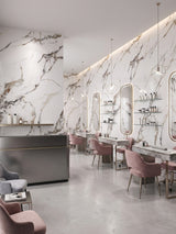 Contemporary salon with Beige Ibiza marble PVC wall panels behind mirrors and pink styling chairs