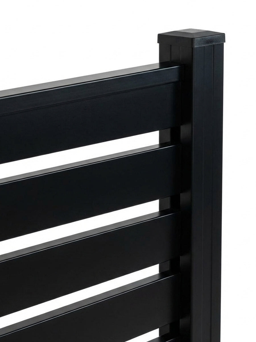 Close-up of black aluminum fence slats secured to the capped post