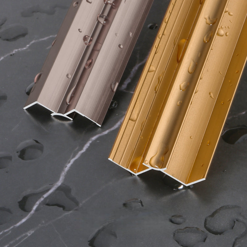 Silver and gold 3mm aluminum inside corner trim profiles with water droplets on dark marble