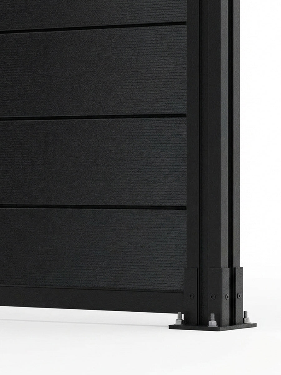 Lower corner detail of the black aluminum privacy fence with horizontal slats and a bolted post base