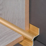 Gold 3mm aluminum inside corner trim fitted around wood-look panel edges