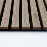 End view of white oak slat profiles and black backing on the acoustic wall panel