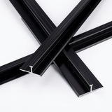Overlapping black aluminum alloy H trim lengths with exposed silver-edged cross sections