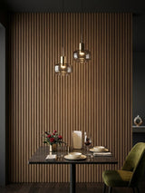 Royal Oak WPC fluted 3D wall panels behind a restaurant dining table with pendant lights