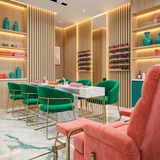 Light oak acoustic wood slat wall panels installed in a modern nail salon with warm lighting