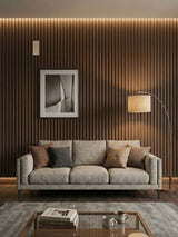 Walnut WPC fluted 3D wall panels installed behind a gray sofa in a modern living room