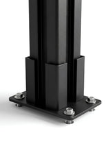 Close-up of the black above-ground fence post base plate secured with mounting hardware