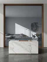 Framed gray mirror wood veneer panel behind a white marble reception counter in a modern office