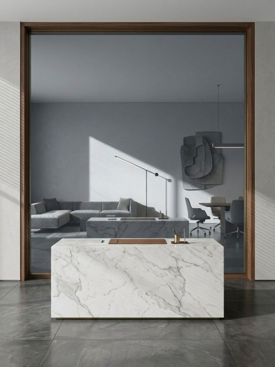 Framed gray mirror wood veneer panel behind a white marble reception counter in a modern office