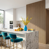 Modern kitchen with a light oak acoustic wood slat feature wall beside a marble island