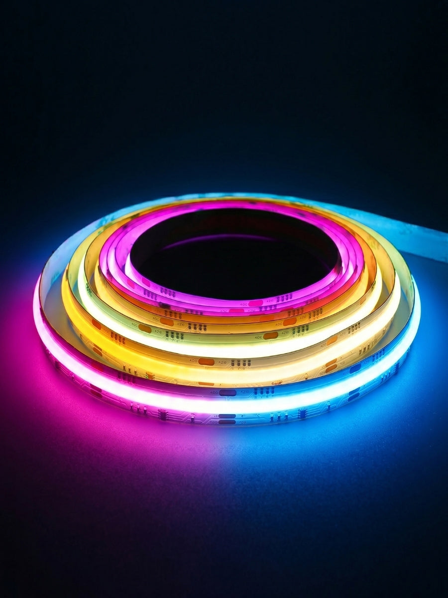 Coiled RGB LED strip glowing pink, yellow, white, and blue against a dark background