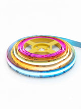 Coiled RGB LED strip lights glowing blue, amber, white, and pink around a yellow reel