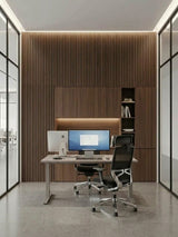 Walnut WPC fluted wall panels installed behind a desk and built-in office cabinetry