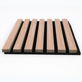 Low-angle view of raised natural wood slats and black backing on the acoustic wall panel