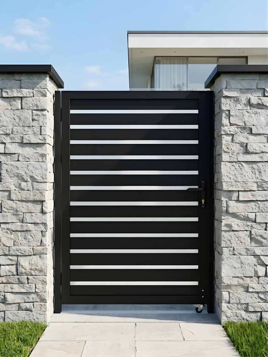 Modern black horizontal-slat aluminum gate installed between gray stone walls