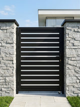 Modern black horizontal-slat aluminum gate installed between gray stone walls