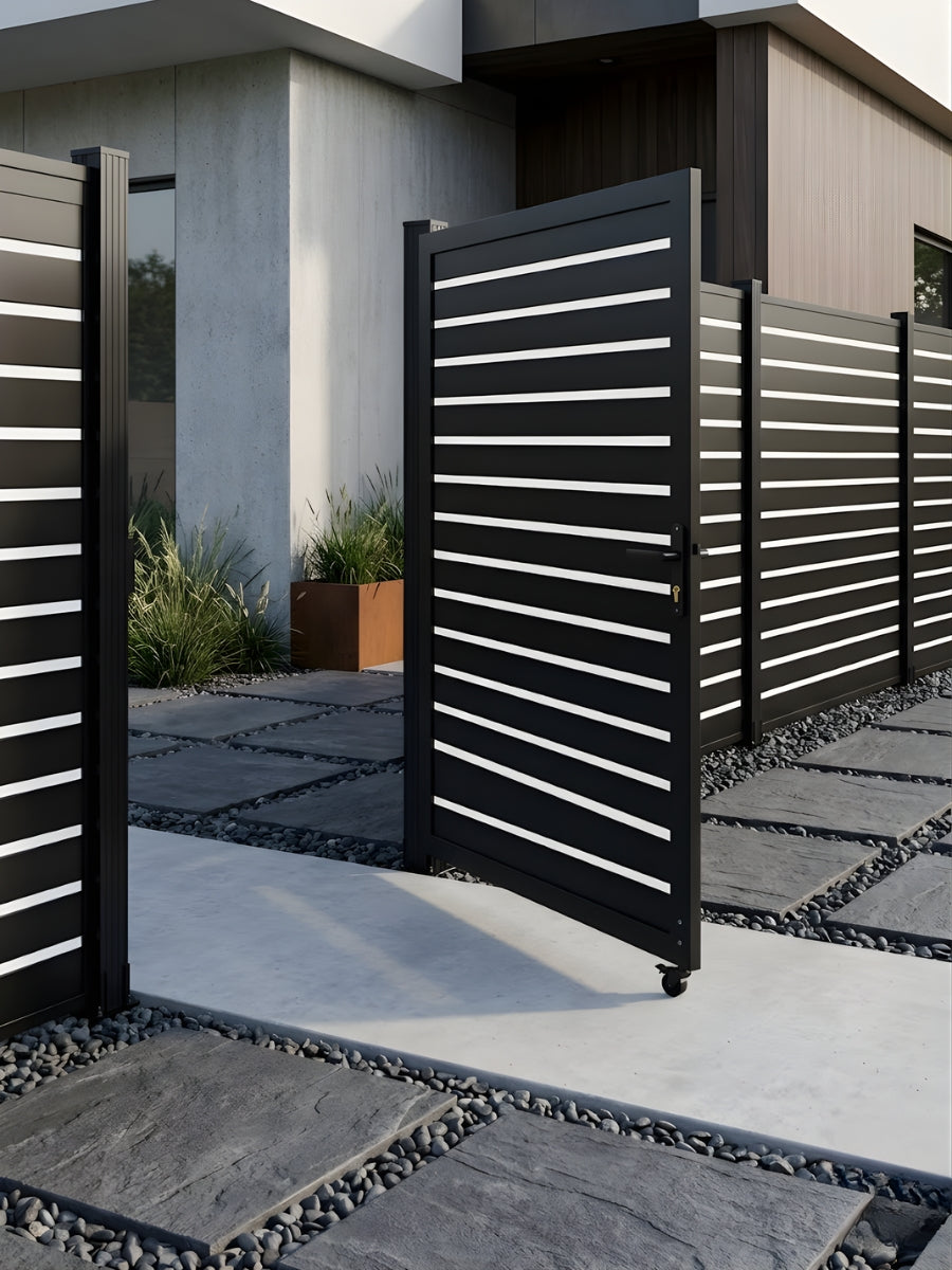 Black aluminum semi-privacy gate installed with matching horizontal-slat fencing at a modern home