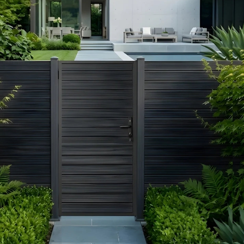 Modern aluminum full privacy gate installed in matching horizontal-slat fencing by a landscaped patio