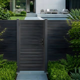 Modern aluminum full privacy gate installed in matching horizontal-slat fencing by a landscaped patio
