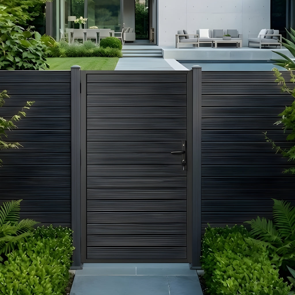 Modern aluminum privacy gate and matching fence installed beside a landscaped pool area