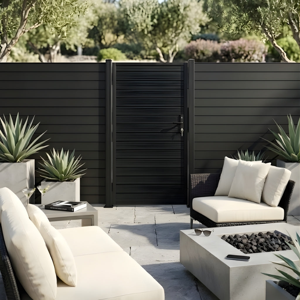Dark aluminum privacy gate installed in a contemporary patio with lounge seating and a fire pit