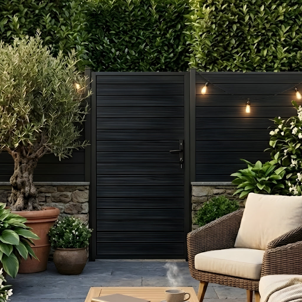 Aluminum full privacy gate with horizontal slats in a garden patio beside seating and string lights